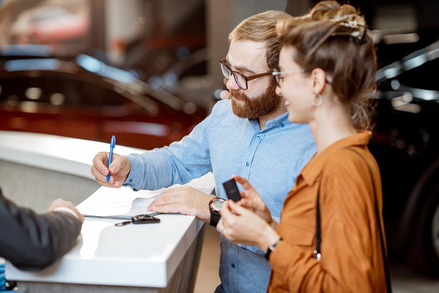 a couple with auto loan financing ready to buy a new car