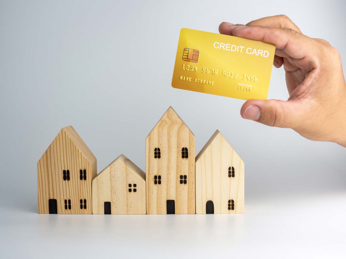 holding credit card over a house