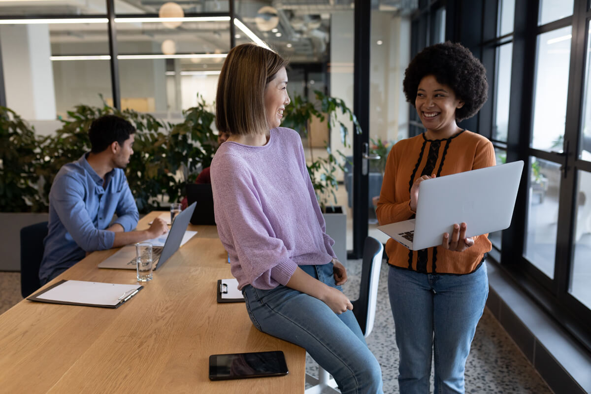 Coworkers discuss how to get a business line of credit to expand their business