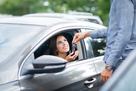 happy car owner after meeting auto loan financing requirements