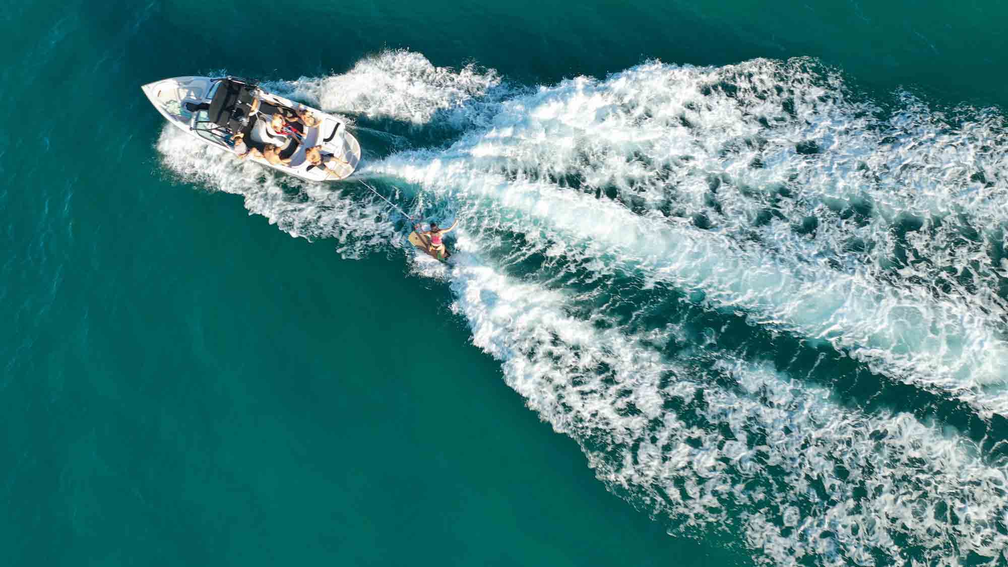 a man enjoys the open water with a fishing rod in hand after securing financing for a new boat