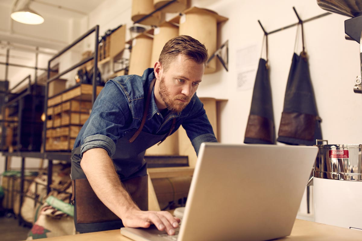 man on laptop in workshop