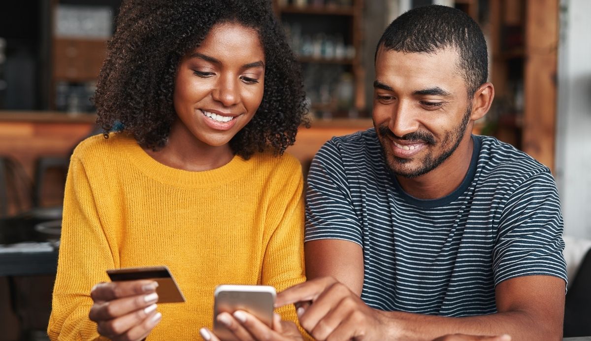 a couple is happy and confident making purchases after researching what to look for in a credit card